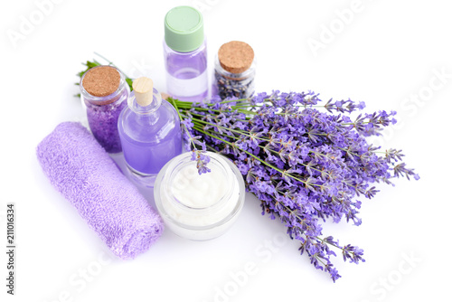 Spa products and lavender flowers on a white background