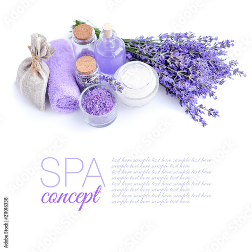 Spa products and lavender flowers on a white background