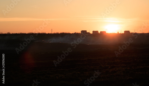 fields in the fire, grey smoke sunset time