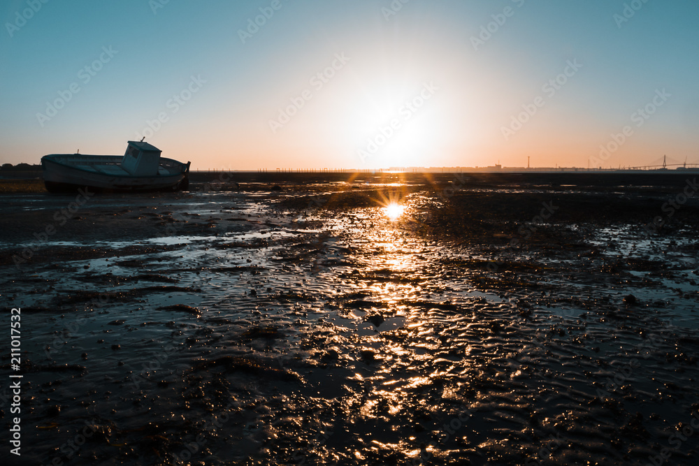 wooden fishing boat at sunset on the beach