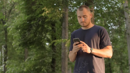 man with a phone and wireless headphones listening to music photo