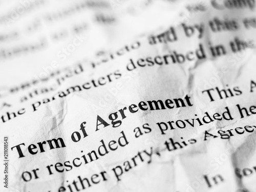 Term of Agreement word message on crumpled and wrinkled contract paper
