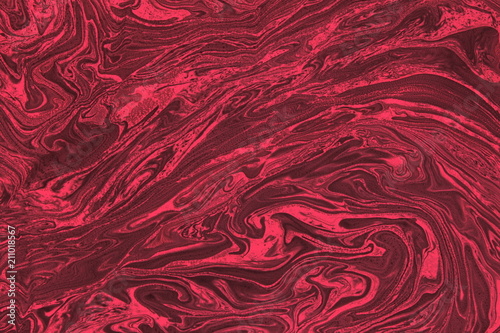 Abstract magical blurred background with different shades of red color and with the texture of the artificial marble stone
