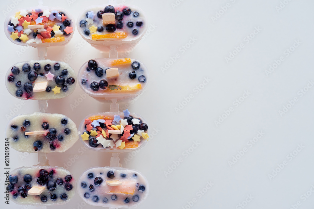 top view of cold homemade ice cream with fruits and berries on grey