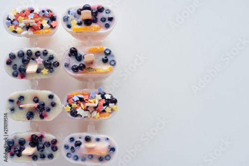 top view of cold homemade ice cream with fruits and berries on grey