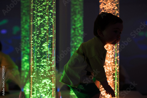 Young kid exploring snoezelen space photo