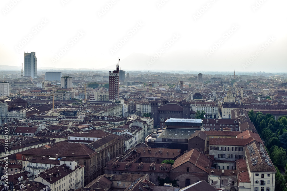 View of a city with a white background due to the fog and the pollution of it. Photograph taken in Turin, Italy.