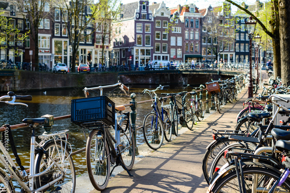 Traditional dutch bicycles parked on the bridge in Amsterdam, th