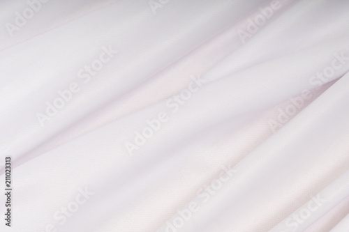 White cloth with pink hue in the folds