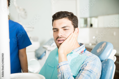 Man Suffering From Toothache In Dental Clinic