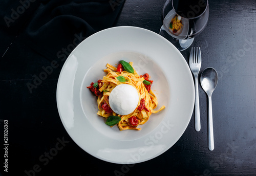 Tasty fettuccine with meat and goat cheese photo