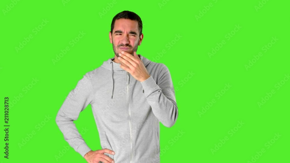 Doubtful young man on chroma key Doubtful young man on chroma key
