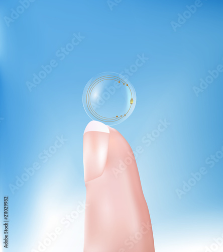 Contact lens with high-tech chip resting on a finger. Technology of the future