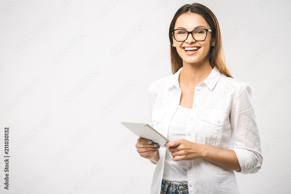 Portrait with copy space empty place of pretty charming confident trendy woman in classic shirt having tablet in hands isolated on white background Portrait with copy space empty place of pretty charming confident trendy woman in classic shirt having tablet in hands isolated on white background