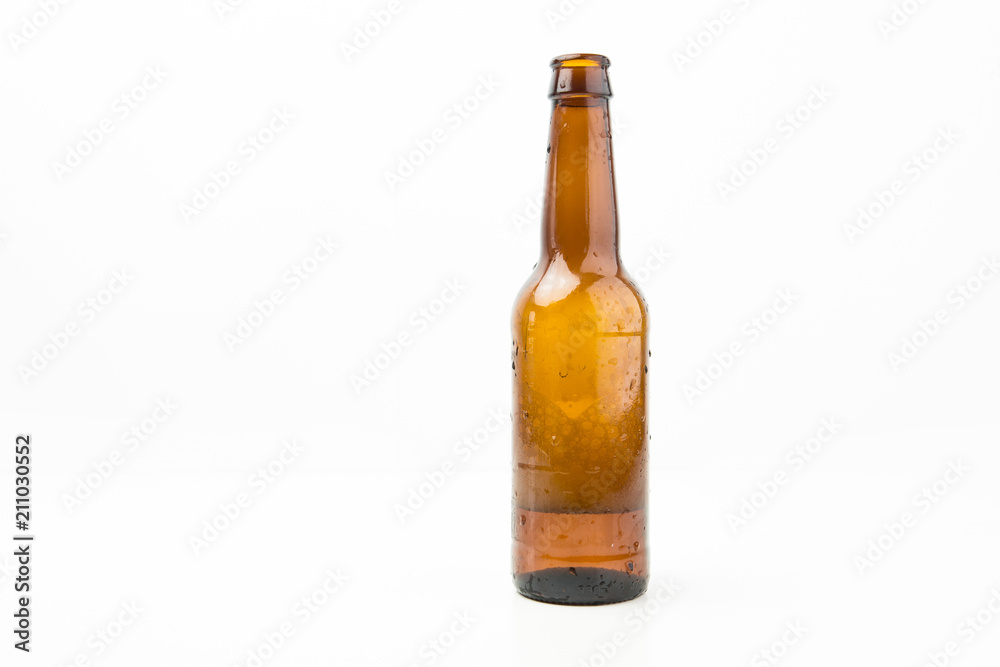 Ice Cold Wet Condensated Lager Beer Bottle With Beer And Foam Inside Isolated On White Background