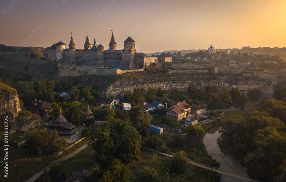 Kamianets-Podilskyi Castle during sunrise. Beautiful view of medieval fortress,  one of the Seven Wonders of Ukraine.