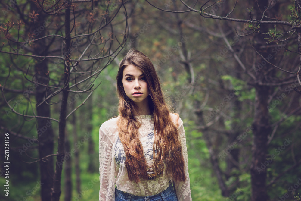 Gorgeous young woman with long hair outdoors in forest. Beautiful teenage girl in woods in twilight. Natural lighting, brownish filter applied, closeup, no retouch. Gorgeous young woman with long hair outdoors in forest. Beautiful teenage girl in woods in twilight. Natural lighting, brownish filter applied, closeup, no retouch.