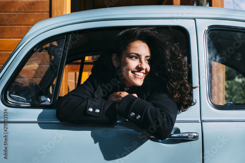 Teen woman inside an old car photo