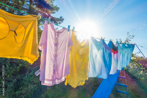 Clothes hanging to dry on a washing line in a back garden
