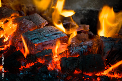 Crest of flame on burning wood in fireplace. Burning firewood in a Russian stove.