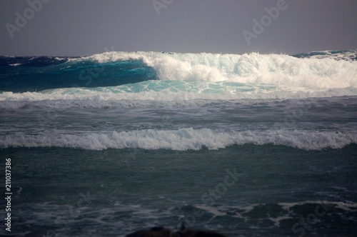 Fototapeta Naklejka Na Ścianę i Meble -  Pacific Ocean Wave Crashing onto a Small Island Shore