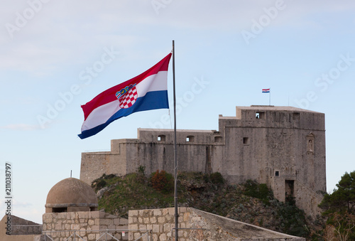 Croatian flag in the background Fort of St. Lawrence (Fort Lovrjenac) in Dubrovnik, Croatia