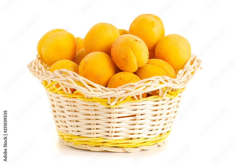 Apricots in a basket orange fruit on a white background isolation Apricots in a basket orange fruit on a white background isolation