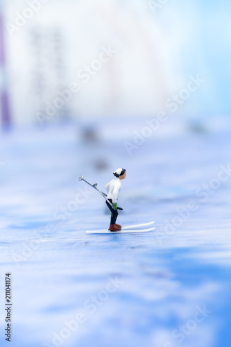 Miniature people, Skier playking ski on snow stream. Image use for sport ,travel concept. photo