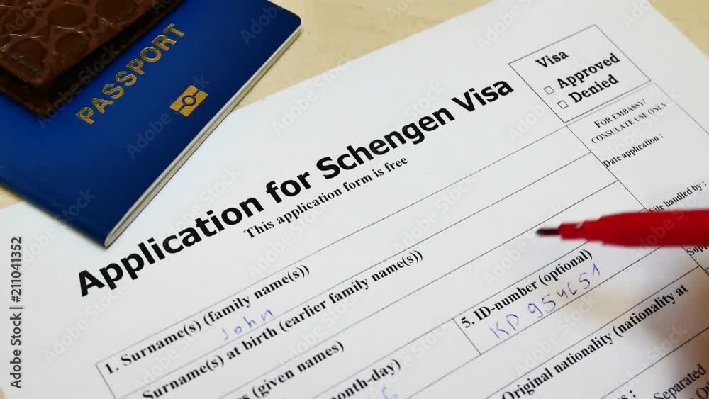 The decision to grant a visa. Pen voting approved in checkbox in blank Schengen Visa application form with passport and pen. Document with passport, apply and permission for foreigner country