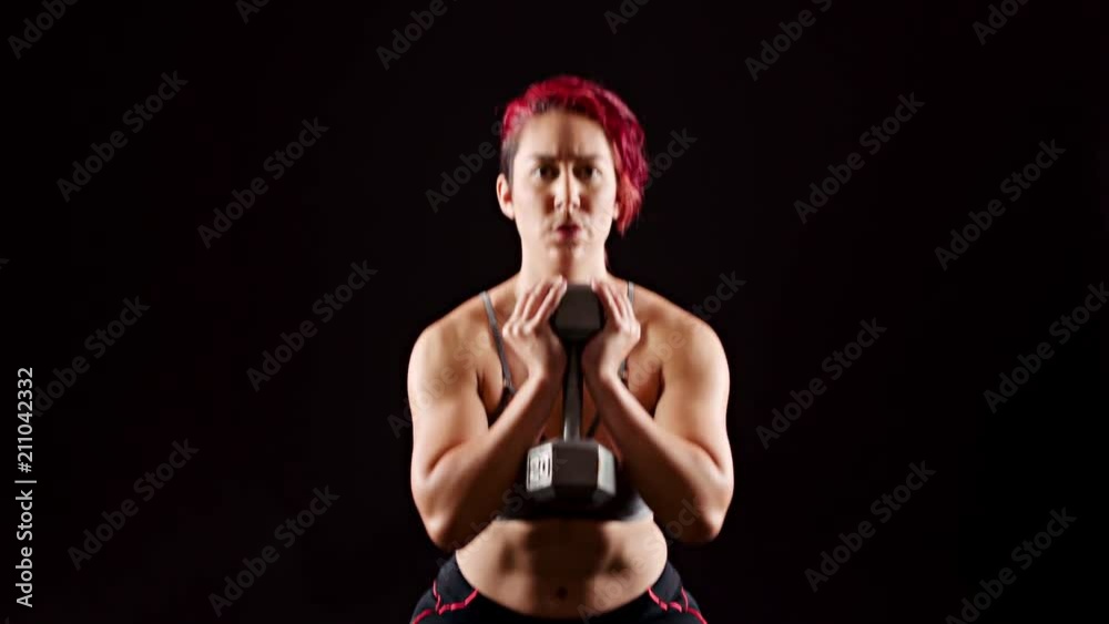 Athletic woman working out with dumbells. Athletic woman working out with dumbells.