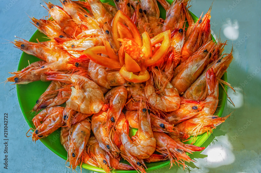 Delicious deep fried shrimp, on a green plate on a wooden table, copy space for text, view from above. Delicious deep fried shrimp, on a green plate on a wooden table, copy space for text, view from above.