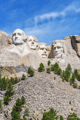 Presidential sculpture at Mount Rushmore national memorial, USA. Blue sky background. Vertical layout. photo