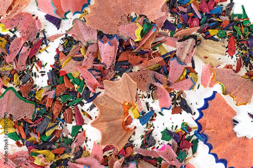 Shavings from multicolored pencils as background. Top view.