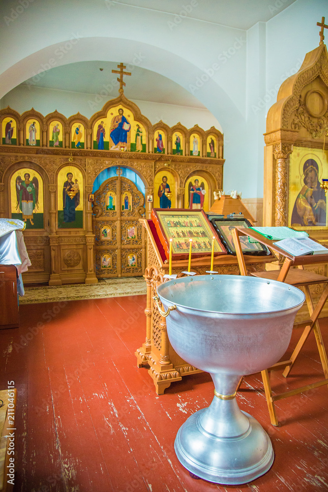 Orthodox church interior. Baptismal font with holy water. Baptism of