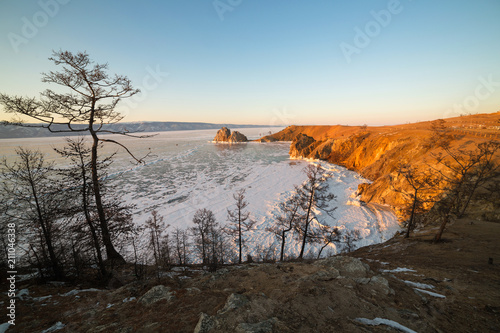 Olkhon island in early spring. Shaman rock and Baikal lake at sunset.