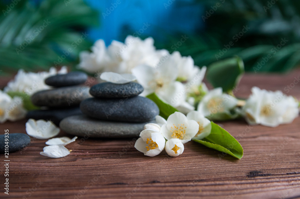 Pyramids of gray zen stones with beautiful fresh white flowers and Buddha statue. Concept of harmony, balance and meditation, spa, massage, relax Pyramids of gray zen stones with beautiful fresh white flowers and Buddha statue. Concept of harmony, balance and meditation, spa, massage, relax
