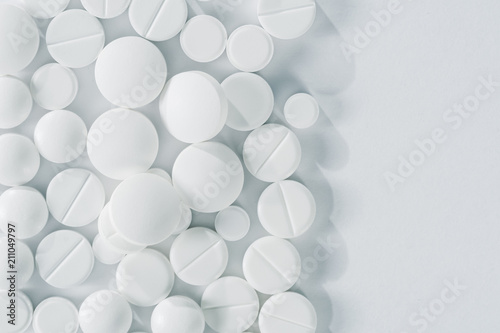 White pills and tablets isolated on white  closeup  top view