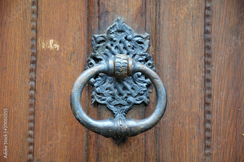 metal doorknocker at wooden door
