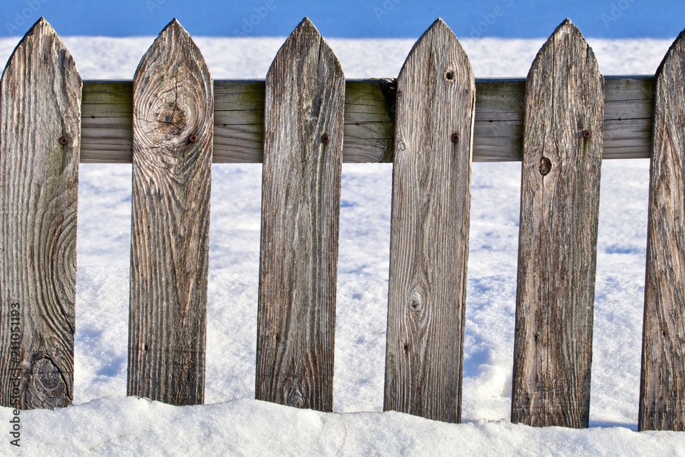 Worn Gray Picket Fence in the Snow