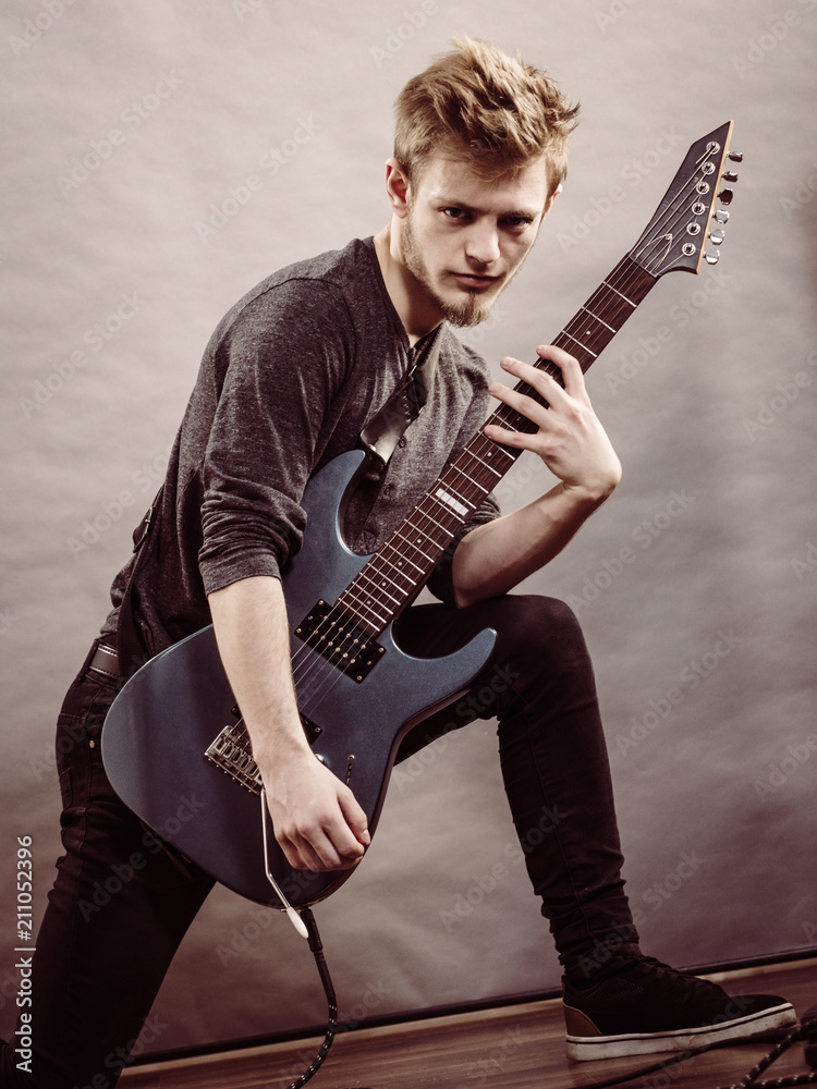 Fototapeta premium Young man playing electric guitar