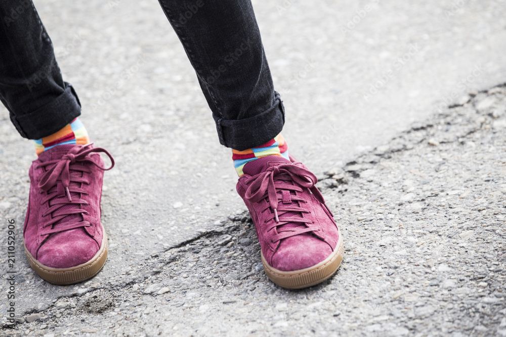 Participant on gay pride wearing rainbow colored socks and pink shoes