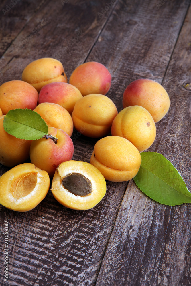 Delicious ripe apricots on wooden table. Fresh cut apricot fruit