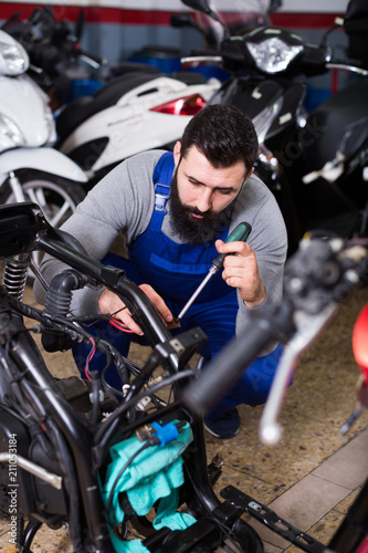 Worker repairing motorbike