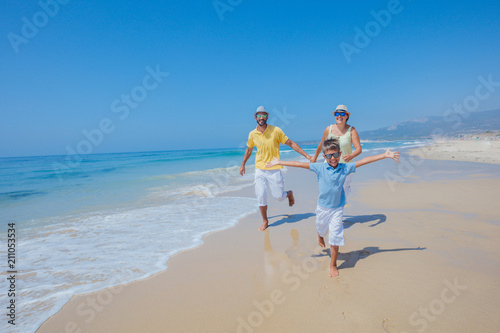 Photos Family having fun and running on a sandy beach