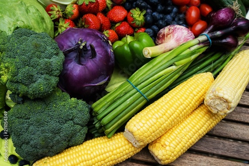 Fresh organic fruits and vegetables on a wooden table       