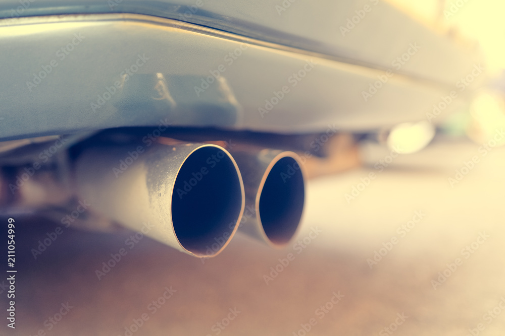 Close up of car exhaust pipe. Toned.