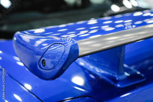 Blue racing spoiler on the car Close-up. The concept of a sports car.