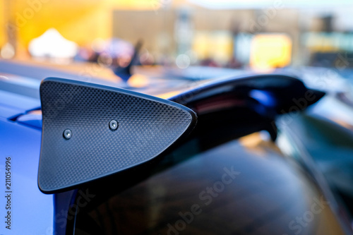 Black racing spoiler on the car Close-up. The concept of a sports car.