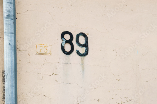 house number 89 on the wall ( eighty nine. ) photo