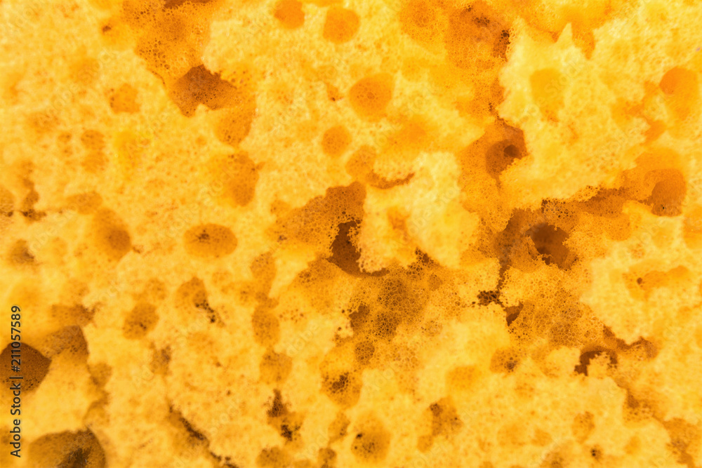texture worn yellow sponge for washing dishes , close-up abstract background texture worn yellow sponge for washing dishes , close-up abstract background